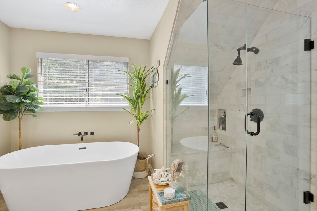 Spa bathroom with a freestanding tub and a glass shower.